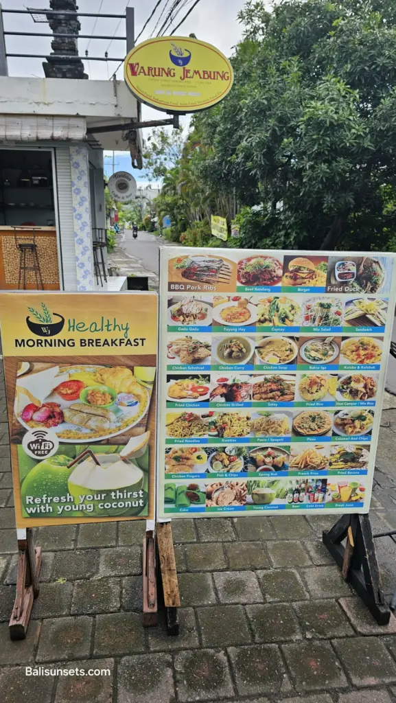 Colorful Bali warung menu sign displaying a wide variety of local and international dishes outside a small eatery
